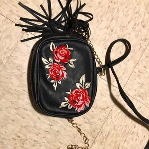 Black embroidered floral purse with strap.